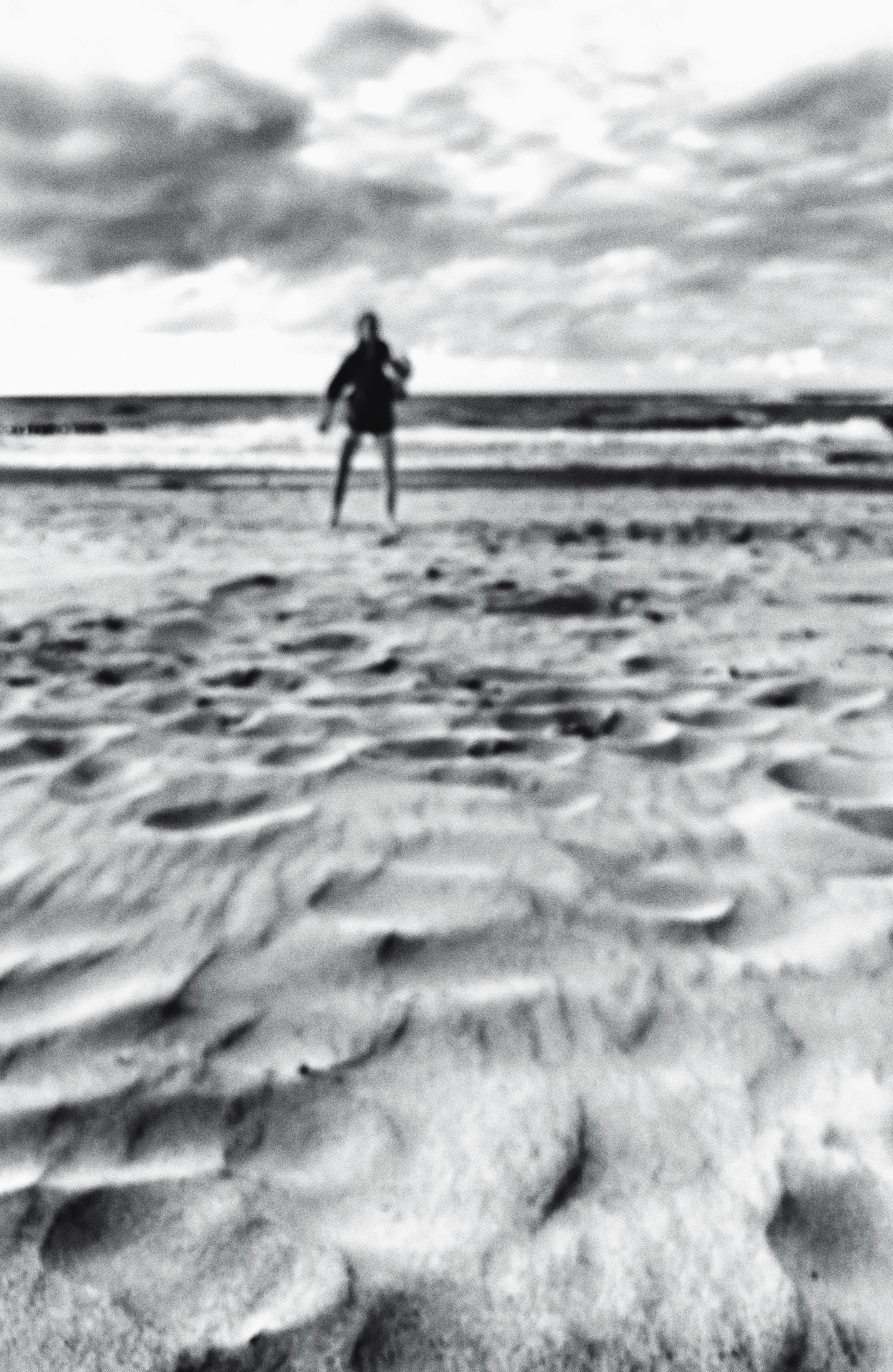 A unsharp pictute of a person at the beach of the baltic sea.